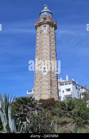 The lighthouse at Estepona in Spain. It stands on the headland known as Punta Doncella at the west end of La Rada beach , close to the marina Stock Photo