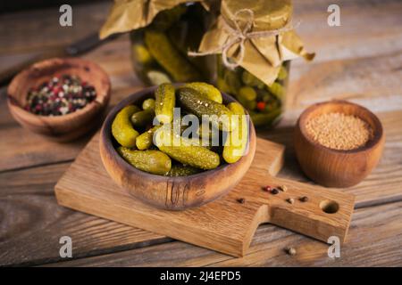 Plate of gherkins, pickled cucumbers on a rustic wooden background Stock Photo