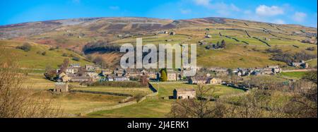 Panoramic view of Gunnerside, Yorkshire Dales National Park. Dry stone walls surround pastures on the hillside above the village, and spoil heaps from Stock Photo