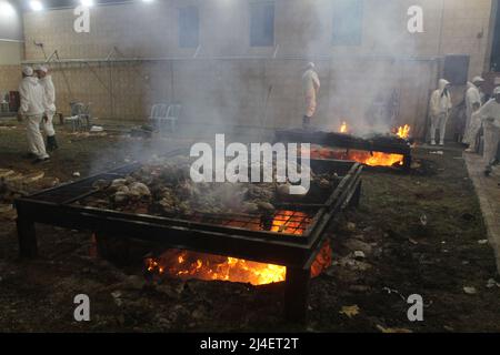 April 14, 2022, Nablus, West bank, Palestine: Members of the ancient Samaritan community burn the remains of sacrifices during their participation in the Passover rituals on Mount Gerizim, overlooking the West Bank city of Nablus. The Samaritans are descended from the ancient Israelite tribes of the Menashe and Ephraim but separated from mainstream Judaism 2,800 years ago. Today, the remaining 700 Samaritans live in the West Bank Palestinian city of Nablus and the Israeli port city of Holon south of Tel Aviv. (Credit Image: © Nasser Ishtayeh/ZUMA Press Wire) Stock Photo