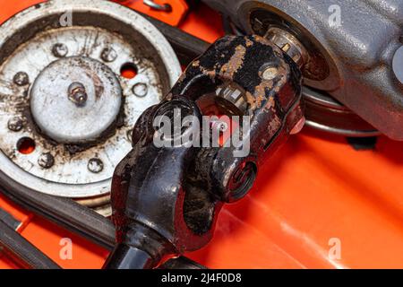 Lawn mower deck power take off driveshaft. Lawn equipment maintenance, repair, and service concept. Stock Photo