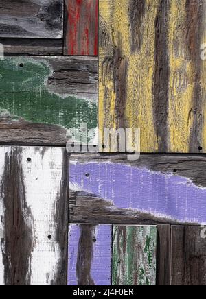 Aged and faded multi colored painted wood planks arranged in geometric patterns. Stock Photo