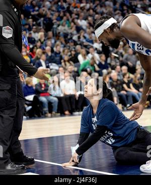 Minneapolis, United States. 15th Apr, 2022. A woman attempts to glue her hand to the court as the Minnesota Timberwolves play host to the Los Angeles Clippers at Target Center on April 12, 2022, in Minneapolis. (Photo by Carlos Gonzalez/Minneapolis Star Tribune/TNS/Sipa USA) Credit: Sipa USA/Alamy Live News Stock Photo