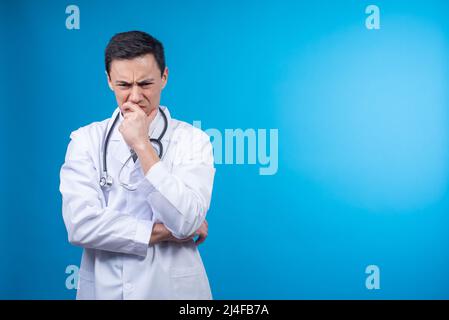 Concerned doctor thinking about problems in studio Stock Photo