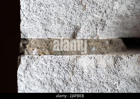 Close-up of an aerated concrete wall with an adhesive layer. Aerated concrete pores close up Stock Photo