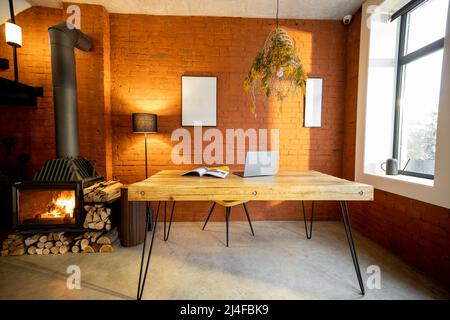 Liiving room interior with a wooden dining table and fireplace Stock Photo