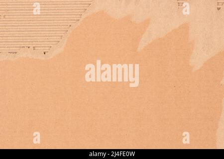 Brown corrugated cardboard with torn edges. Cardboard packaging mesh texture background. Top view, copy space Stock Photo