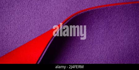 Abstract geometric felt texture background. Creative geometric curved felt textile background in red and purple colors. Top view, copy space Stock Photo