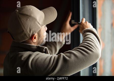 handsome young man installing bay window in a new house Stock Photo