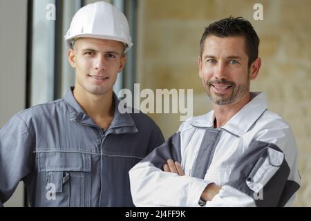 portrait of two construction workers wearing hard hats Stock Photo