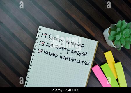 Safety Concept Before Start Work Checklist write on sticky notes isolated on Wooden Table. Stock Photo