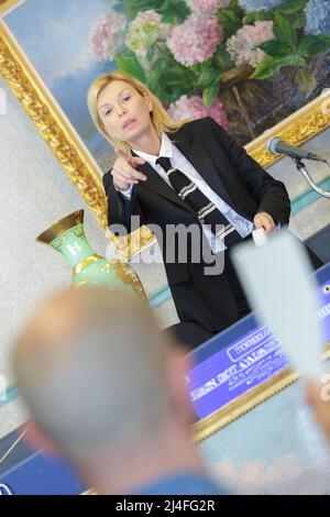 people holding auction paddle to buy from auction Stock Photo
