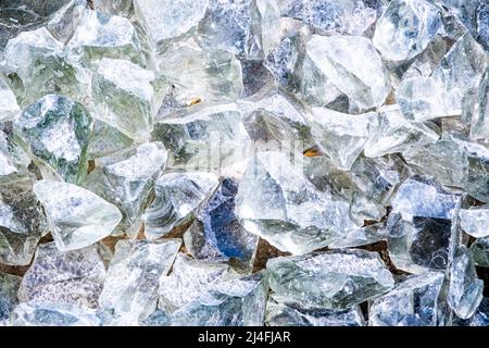 Raw Glass Rocks. Big ice crystal pieces in different size and rough pattern for decoration purposes. Top view on hart and sharp cut objects. Breakable Stock Photo
