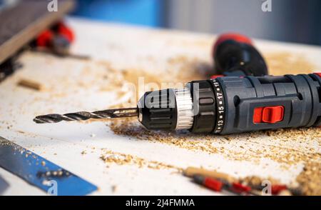 Drill lying on carpenter's table Stock Photo