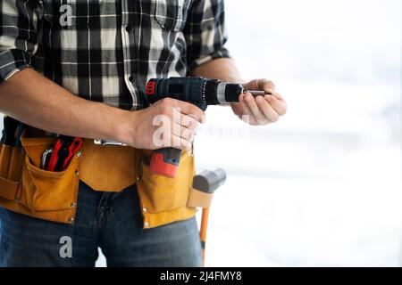 Worker working with electric screwdriver Stock Photo