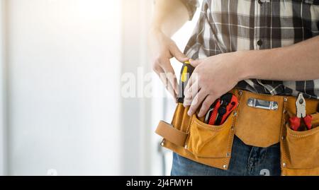 Worker assembler with tool belt Stock Photo