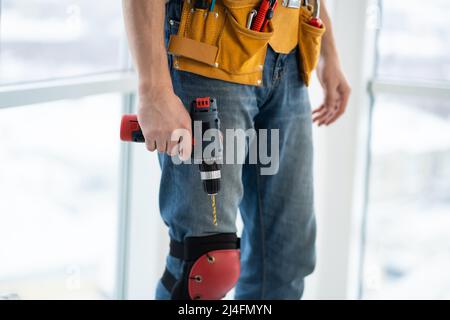 Worker in mounting belt with screwdriver Stock Photo