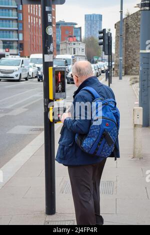 Man waiting to cross the road / The Strand, Liverpool Stock Photo