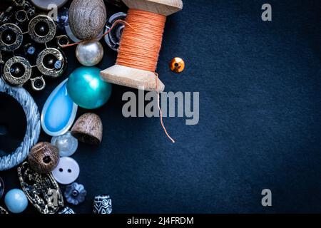 Sewing accessories on dark blue background with copy space Stock Photo