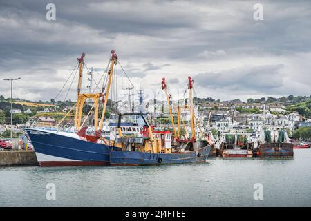 Large fishing boats moored in Howth harbour. Phishing and shellfish fishing equipment on fishing boats, Dublin, Ireland Stock Photo