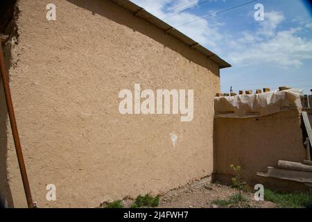 Traditional asian house in village built from adobe bricks. Bricks made from mix clay and straw. Stock Photo