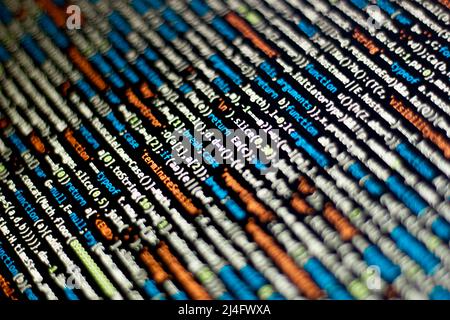 The software developer does the coding. Abstract code screen for use as a background. The programmer does web coding. Selective focus Stock Photo