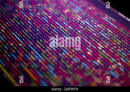 The software developer does the coding. Abstract code screen for use as a background. The programmer does web coding. Selective focus Stock Photo