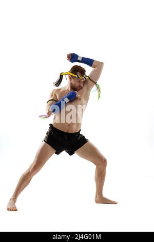 Portrait of professional thai boxer practicing isolated on white studio background. Sport, muay thai, competition, fight club concept Stock Photo