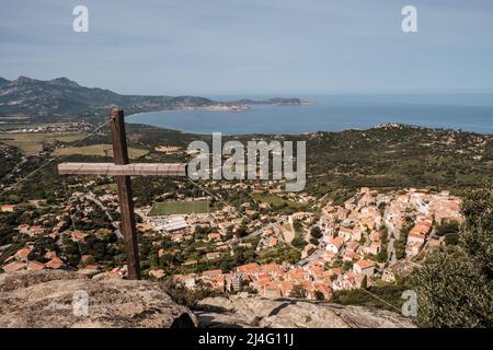 View over the village of Lumio and the bay of Calvi and Revellata from a wooden cross in the Balagne region of Corsica Stock Photo