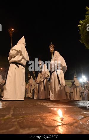 Sorrento, Italy. 14th Apr, 2022. Hooded Penitents of the Arciconfraternita di Santa Monica carry crosses and torches as they take part in Good Friday procession long the streets of Sorrento Southern Italy. Christian believers around the world mark the Holy Week of Easter in celebration of the crucifixion and resurrection of Jesus Christ. Sorrento on April 15, 2022 in Naples, Italy. Credit: Franco Romano/Alamy Live News Stock Photo