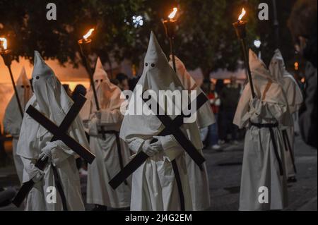 Sorrento, Italy. 14th Apr, 2022. Hooded Penitents of the Arciconfraternita di Santa Monica carry crosses and torches as they take part in Good Friday procession long the streets of Sorrento Southern Italy. Christian believers around the world mark the Holy Week of Easter in celebration of the crucifixion and resurrection of Jesus Christ. Sorrento on April 15, 2022 in Naples, Italy. Credit: Franco Romano/Alamy Live News Stock Photo