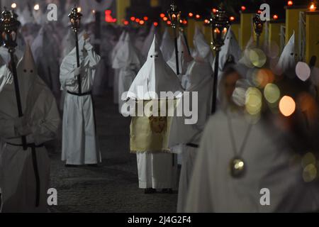 Sorrento, Italy. 14th Apr, 2022. Hooded Penitents of the Arciconfraternita di Santa Monica carry crosses and torches as they take part in Good Friday procession long the streets of Sorrento Southern Italy. Christian believers around the world mark the Holy Week of Easter in celebration of the crucifixion and resurrection of Jesus Christ. Sorrento on April 15, 2022 in Naples, Italy. Credit: Franco Romano/Alamy Live News Stock Photo