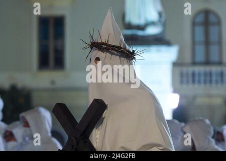 Sorrento, Italy. 14th Apr, 2022. Hooded Penitents of the Arciconfraternita di Santa Monica carry crosses and torches as they take part in Good Friday procession long the streets of Sorrento Southern Italy. Christian believers around the world mark the Holy Week of Easter in celebration of the crucifixion and resurrection of Jesus Christ. Sorrento on April 15, 2022 in Naples, Italy. Credit: Franco Romano/Alamy Live News Stock Photo