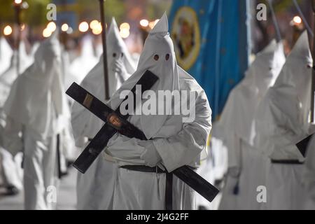 Sorrento, Italy. 14th Apr, 2022. Hooded Penitents of the Arciconfraternita di Santa Monica carry crosses and torches as they take part in Good Friday procession long the streets of Sorrento Southern Italy. Christian believers around the world mark the Holy Week of Easter in celebration of the crucifixion and resurrection of Jesus Christ. Sorrento on April 15, 2022 in Naples, Italy. Credit: Franco Romano/Alamy Live News Stock Photo