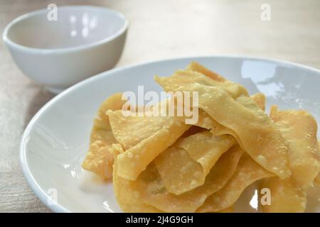 crispy fried dumpling paste stuffed chop pork dipping sweet chili sauce on plate Stock Photo