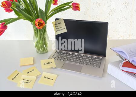Computer security, laptop with various sticky password notes on a white desk, concept for safety in home office, business or study, copy space, select Stock Photo