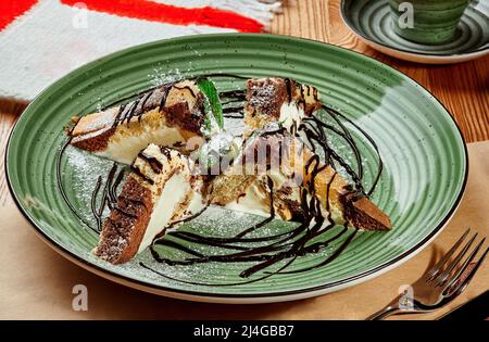 Slices of marble cake with creamy custard and nuts served in Georgian restaurant Stock Photo