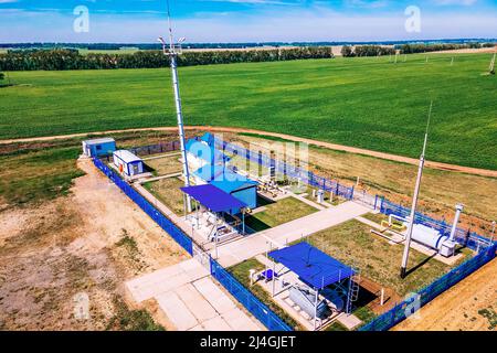 Natural gas distribution station of main gas pipeline. View from above. Type of gasification object on summer day. Construction of gas pipeline. Stock Photo