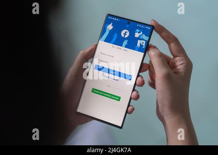 CHIANG MAI, THAILAND, APR 15, 2022 : Samsung Galaxy S22 Ultra in the hand when logging into Facebook applications. Facebook is largest and most Stock Photo