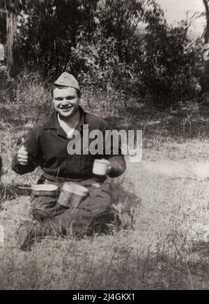 Trekhizbenka village, Luhansk region, USSR - circa 1982: photo of a young cadet in military uniform during a field lunch at a military exercise. Stock Photo