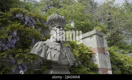 Emperor Alexander III is located in Upper Massandra on the Southern coast of Crimea.Action. Monument next to summer green trees Stock Photo