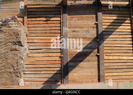 Excavation pit is secured against collapsing with iron girders and timber Stock Photo