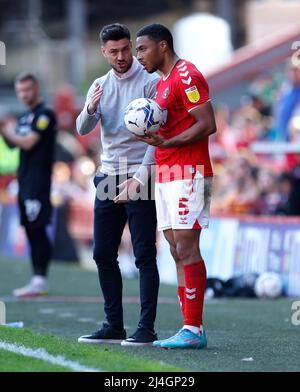 Charlton Athletic manager Johnnie Jackson (left) speaks with Akin Famewo in a break in play during the Sky Bet League One match at The Valley, London. Picture date: Friday April 15, 2022. Stock Photo