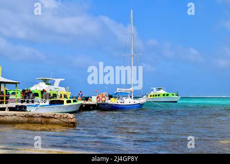 The ferry terminal in San Pedro, Belize on a busy day.  Local workers and passengers waiting to board can be seen. Stock Photo