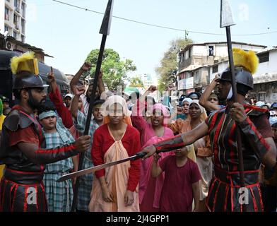 Mumbai, India. 15th Apr, 2022. People participate in a re-enactment during a Good Friday procession. Children, women, priest and nuns participated in a Good Friday procession which portrayed the torture and killing of Jesus Christ enacted through musical play on the streets. Credit: SOPA Images Limited/Alamy Live News Stock Photo