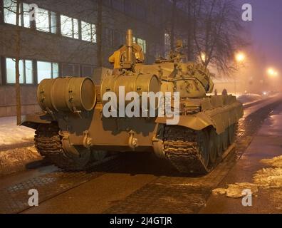 RIGA, LATVIA - February 22, 2021: Real old Soviet tank during movie making about war on the Dzerbenes street in the capital city Stock Photo