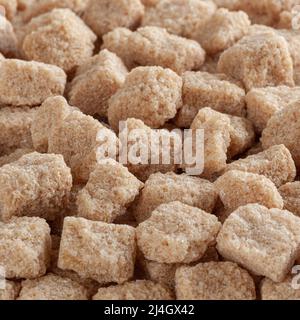 Cubes of brown cane sugar background Stock Photo