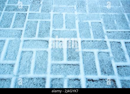 background snow cover the blocks of interlocking pavement Stock Photo