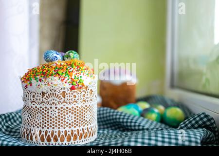 Easter cake with glace icing and easter eggs on black background. Stock Photo