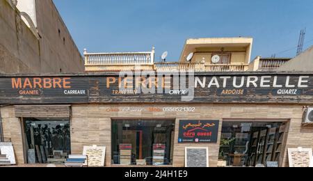 Cera Ouest store facade. Marble natural stone, granite, quartz, slate stone. Exterior showroom with exposed templates. A house with parabolic plates. Stock Photo
